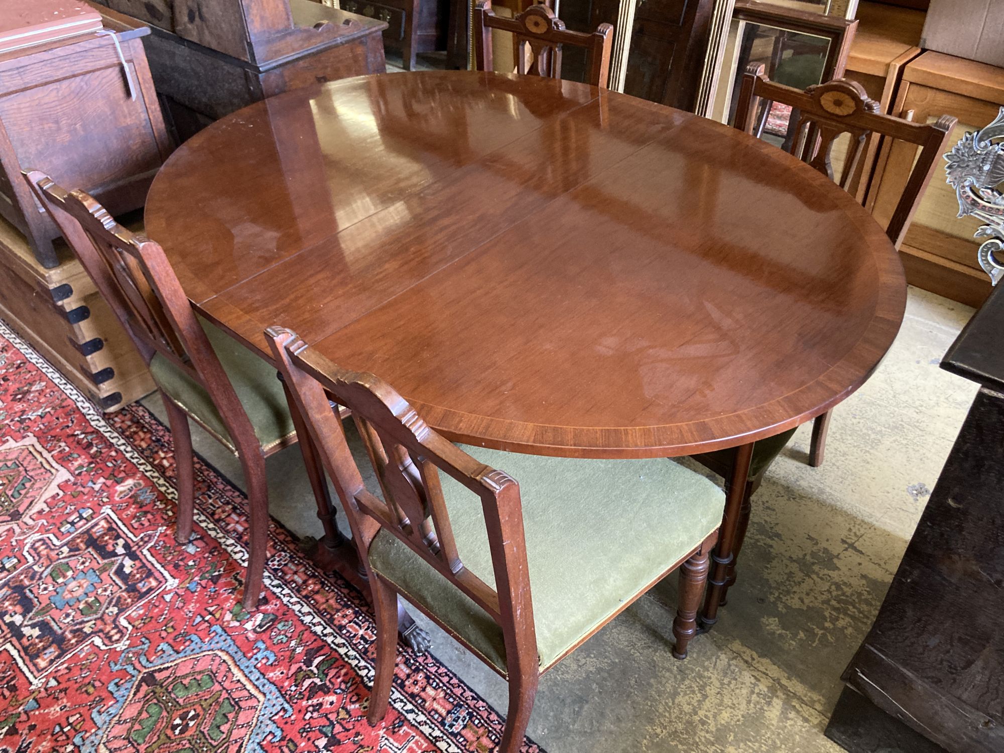 A Victorian style banded mahogany drop flap dining table, 138cm extended together with a set of four Edwardian inlaid mahogany dining c